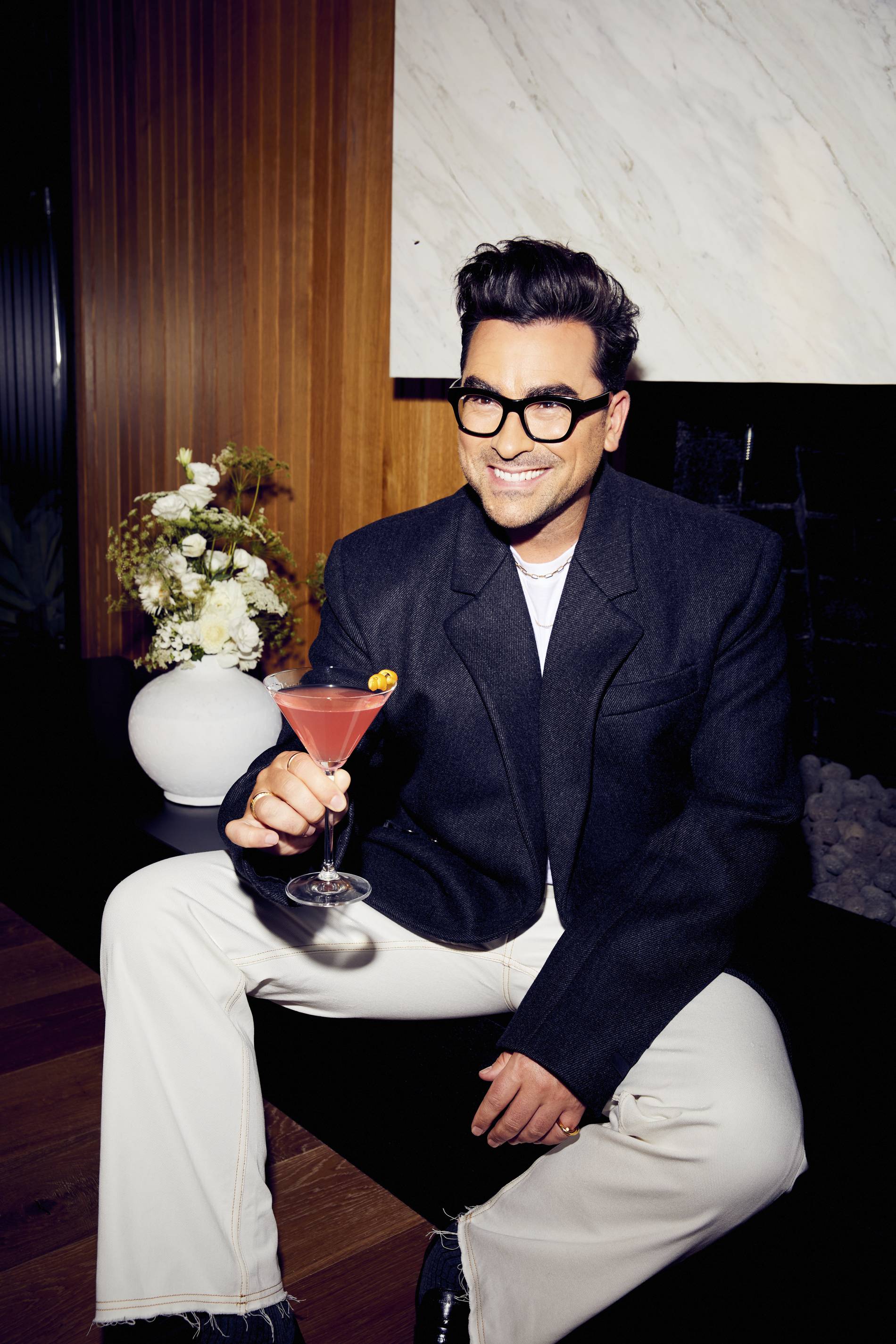 Dan Levy poses with a Cointreau Cosmopolitan cocktail