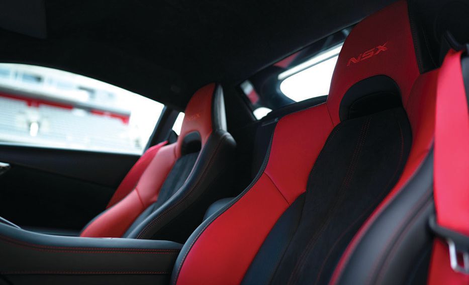 The driver-focused cockpit of the NSX features these formfitting seats upholstered in smooth suedelike Alcantara and semi-aniline leather. Red seat belts and contrast stitching combine with the embossed NSX logos on the headrests to further elevate the NSX’s supercar cred. PHOTO COURTESY OF BRAND