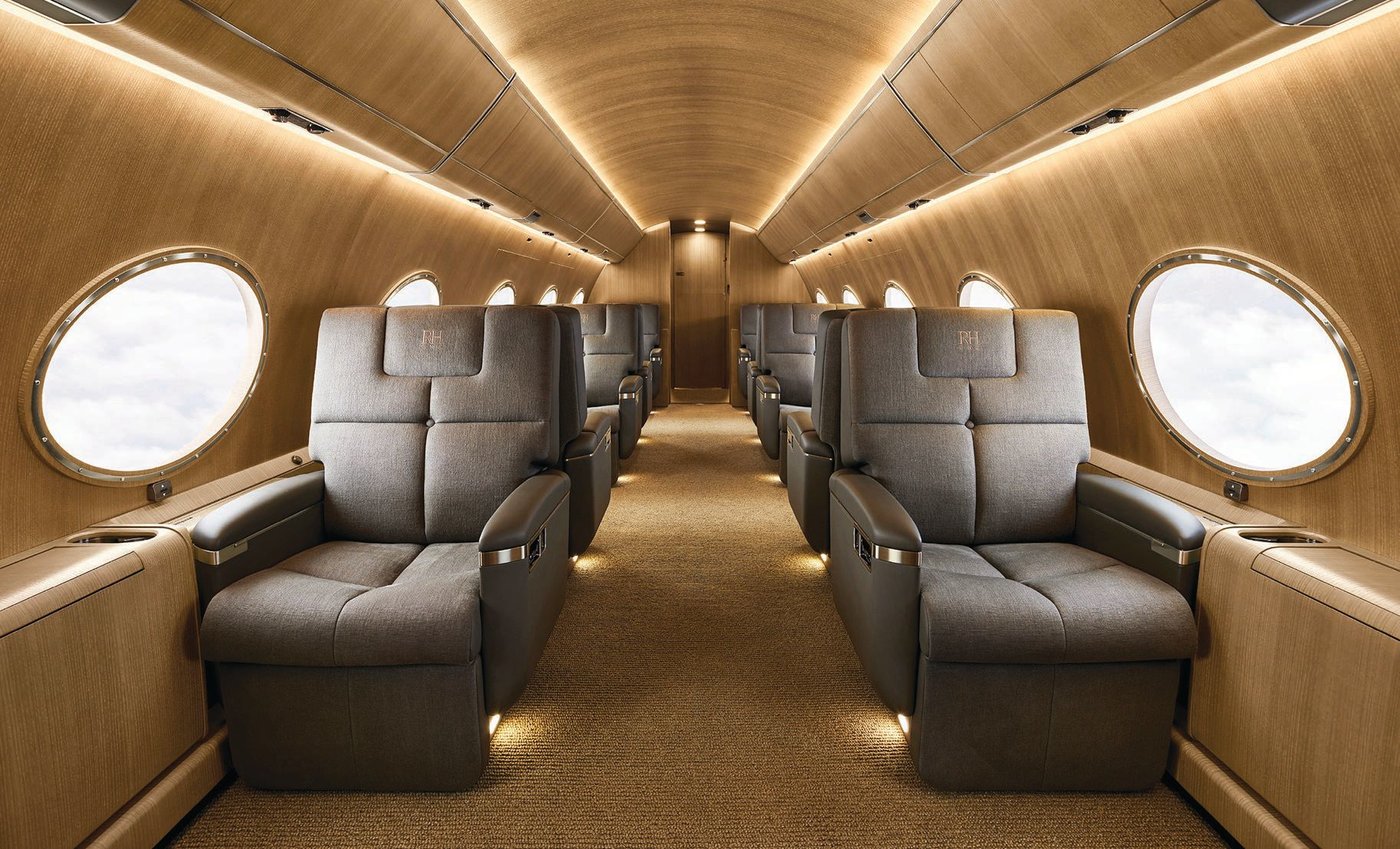The jet’s interior features luxe chairs upholstered in charcoal linen PHOTO BY JOHN VOGLER/COURTESY OF RH