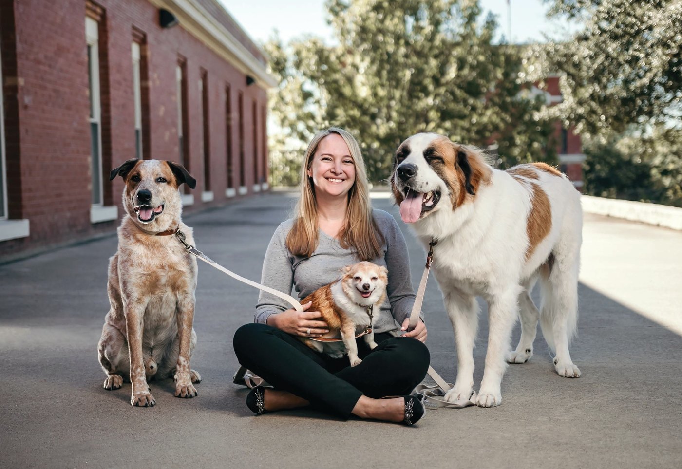 Power player Grace Cook poses for a sweet snap with pups Teddy, Rocky and Zeus. PHOTO BY ROBERT GUERRA