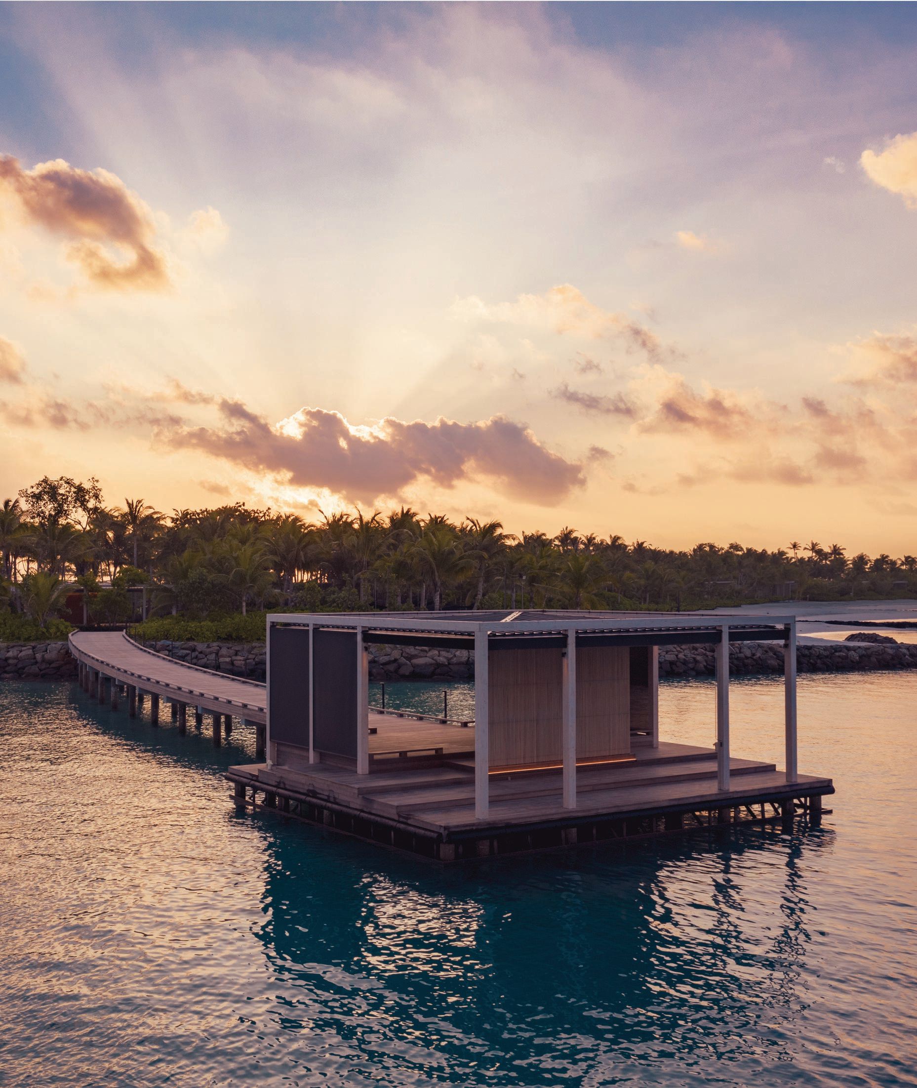 From the resort’s arrival pontoon, guests glimpse the tropical paradise that awaits. PHOTO COURTESY OF THE RITZ-CARLTON MALDIVES, FARI ISLANDS