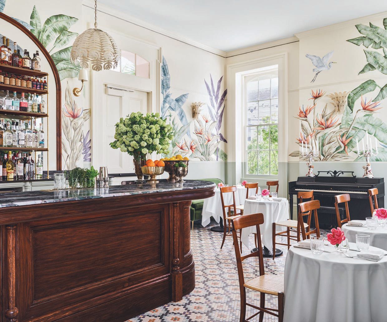 Bathed in light with custom mosaic tiled flooring and handpainted walls from New Orleans-based artist Ann Marie Auricchio, the Paradise Lounge is the perfect spot for a small bite or afternoon spritz PHOTO BY DOUGLAS FRIEDMAN
