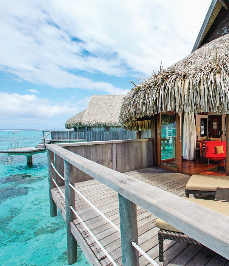 Outdoor showers and private decks off each overwater bungalow allow guests to enter the azure waters below at their leisure