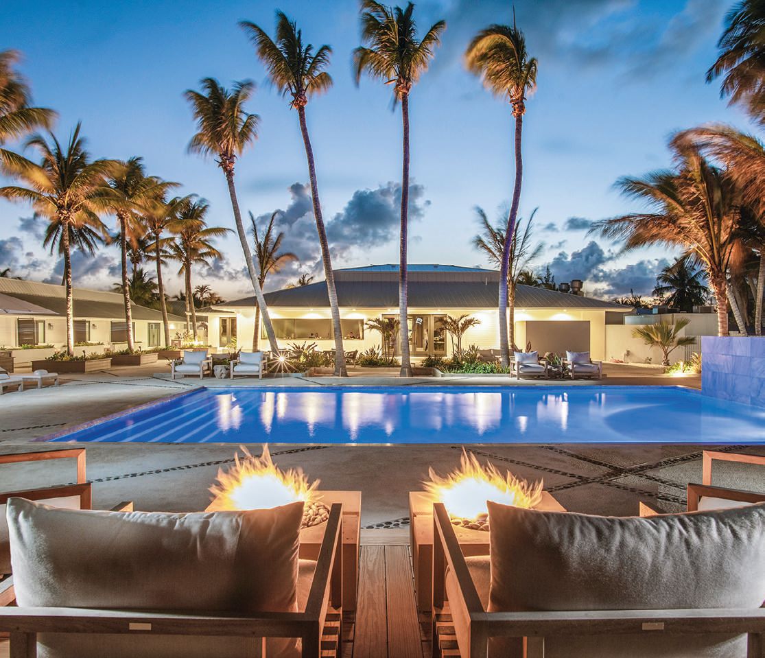 Evening falls on a patio graced by fire pits—the suites and the signature restaurant, Lusca, face the pool PHOTO COURTESY OF CAERULA MAR CLUB