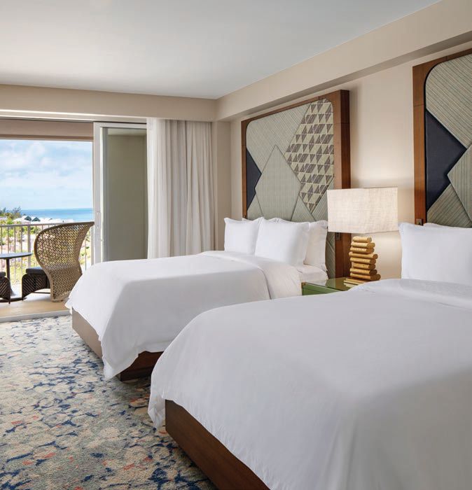 Plush bedrooms feature simple yet sophisticated design, meant to complement the stunning views from the balcony PHOTO COURTESY OF THE ST. REGIS BERMUDA RESORT