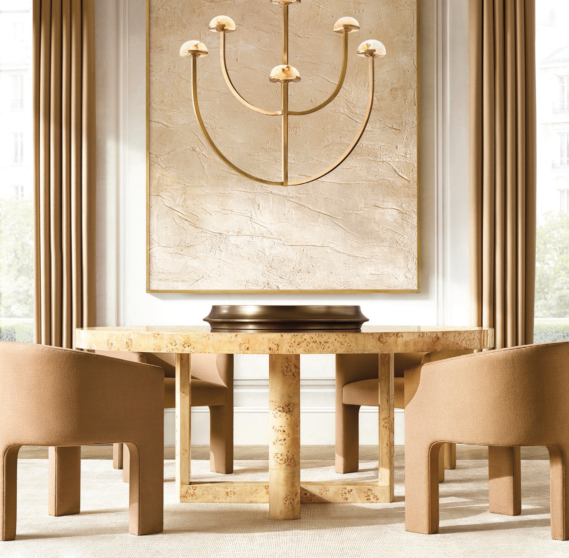 RH Contemporary Bardot Burl round dining table and Inés Dining Chair by the Van Thiels PHOTO COURTESY OF BRAND