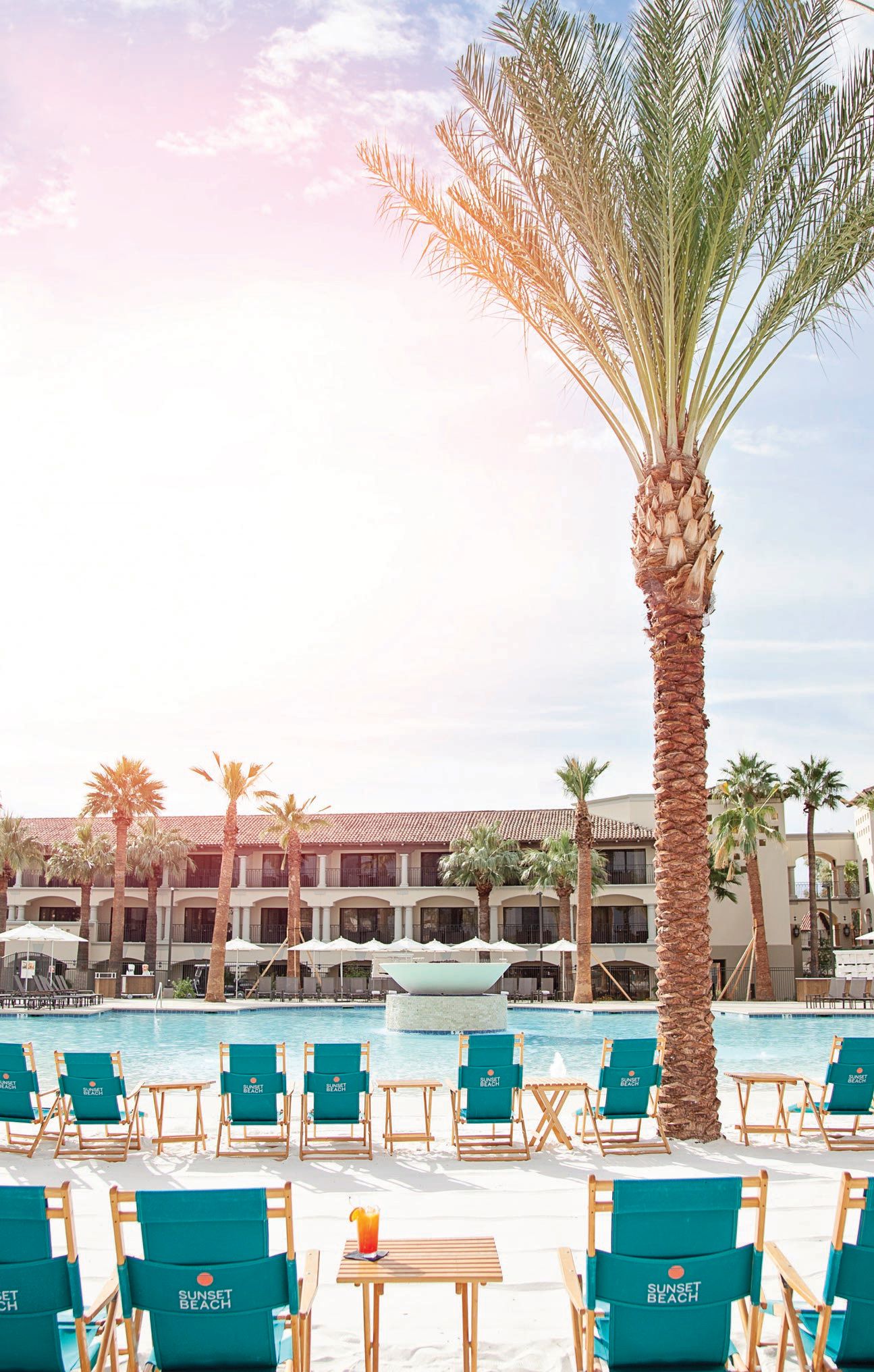The sun rises at Sunset Beach, one of six pools at the Fairmont Scottsdale Princess. Th is unlikely oasis sits on 9,000 square feet of powdery white sand. PHOTO COURTESY OF BRANDS