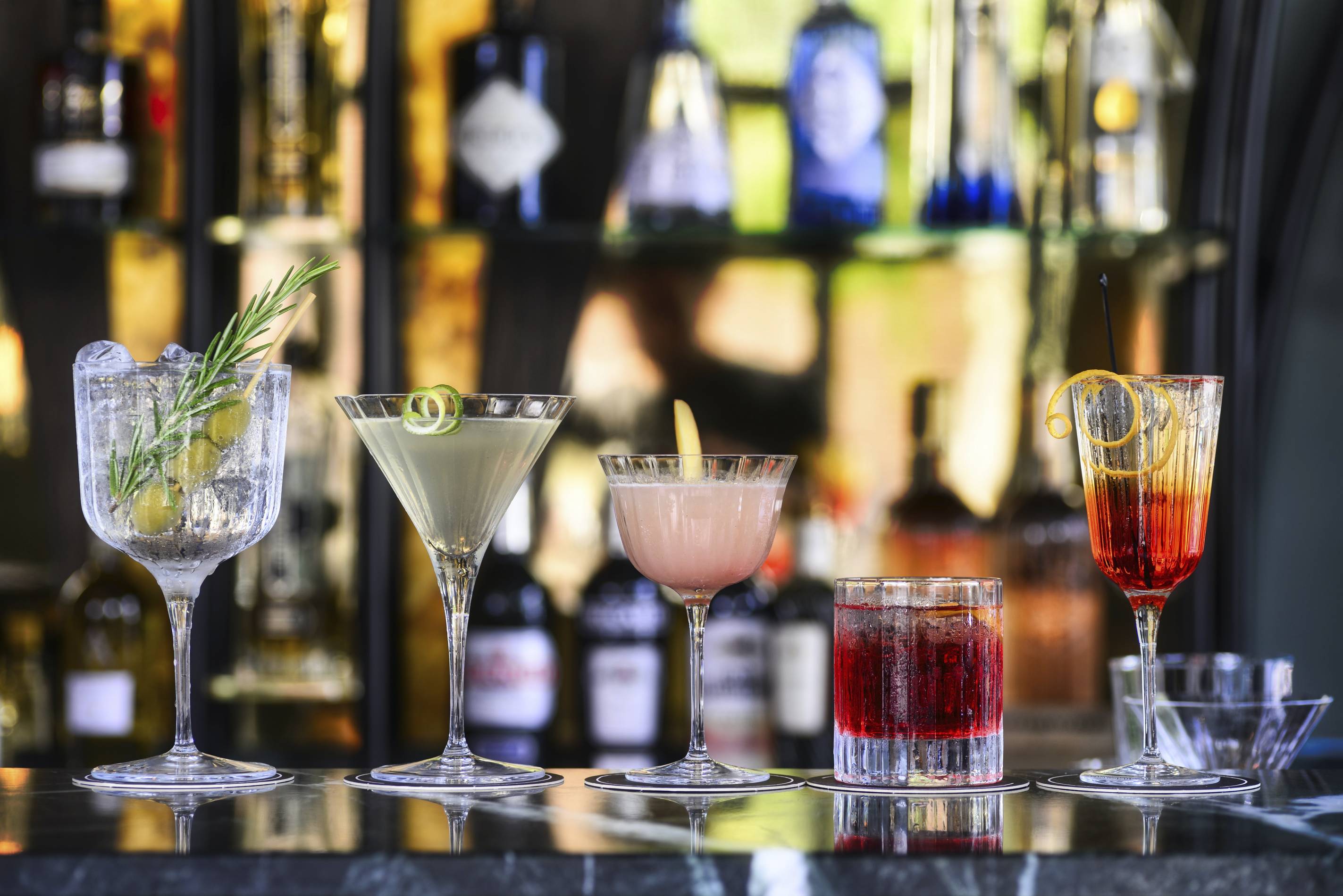 An assortment of cocktails on a bar