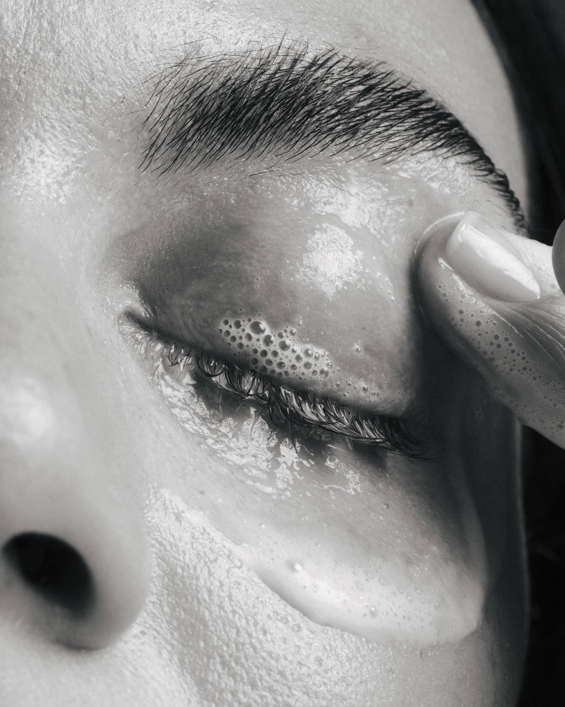 a woman cleanses her eyes