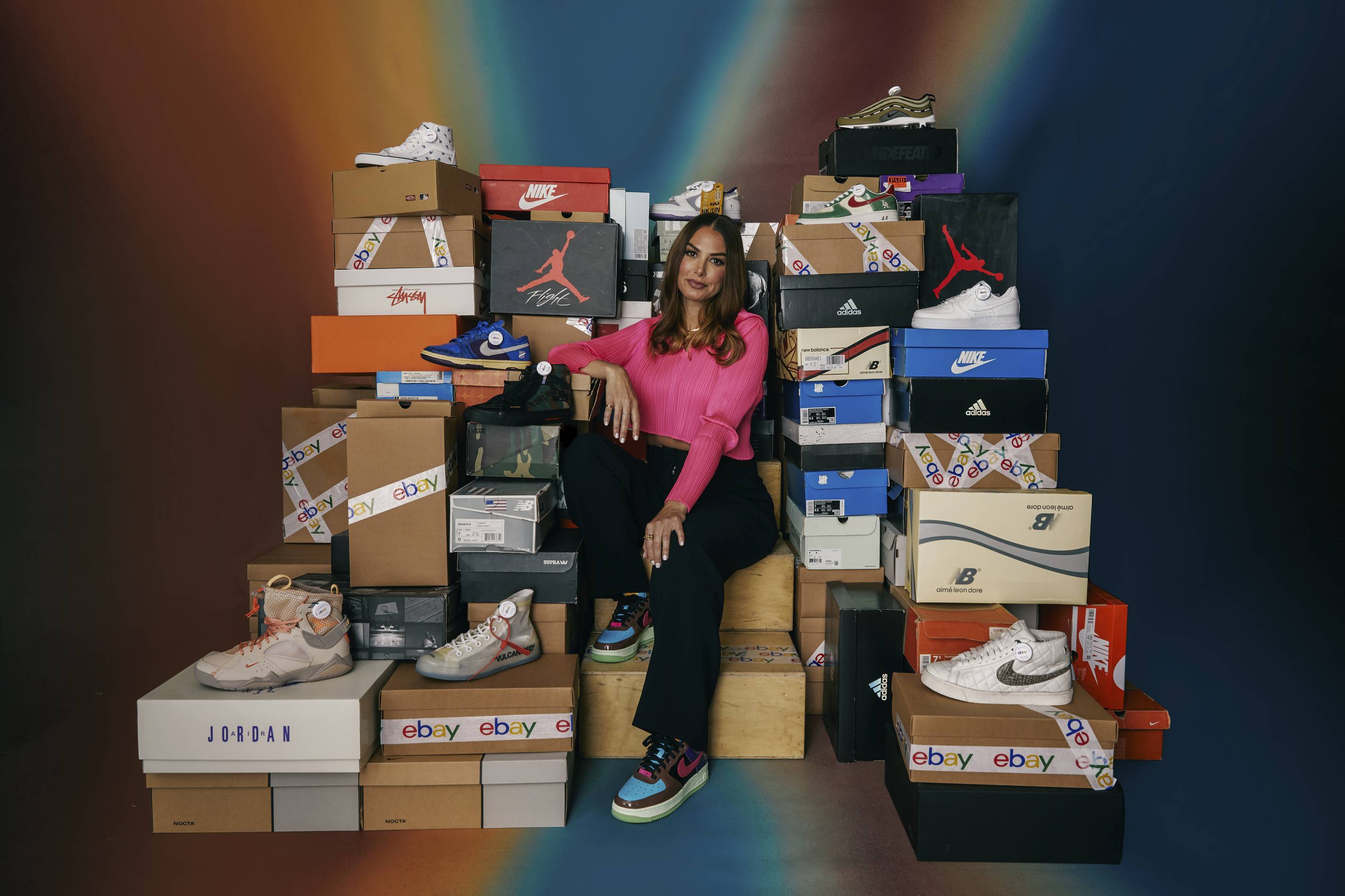 Joy Claire poses with her sneaker collection heading to auction on eBay