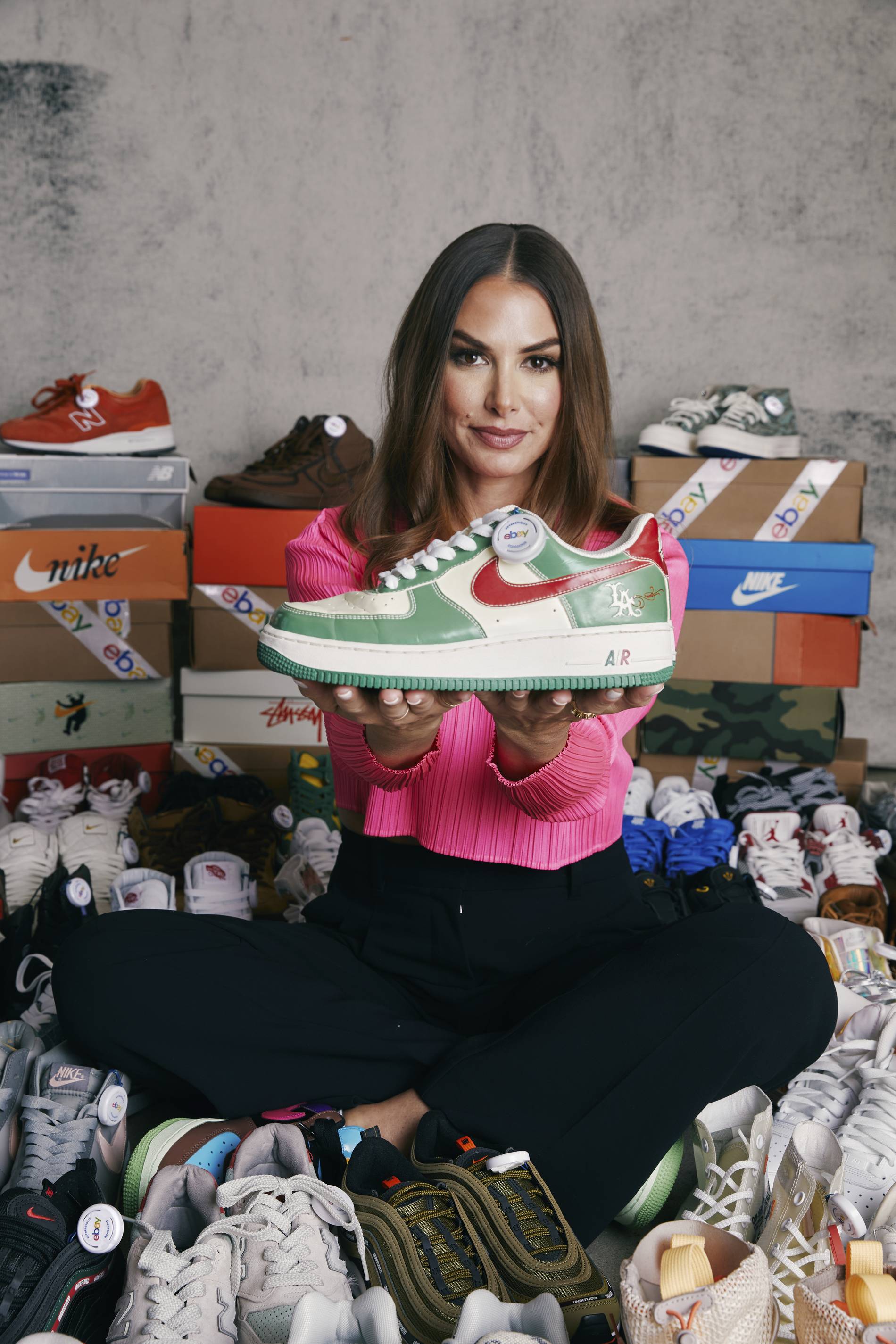 Joy Claire poses with her sneaker collection, going up for auction on eBay