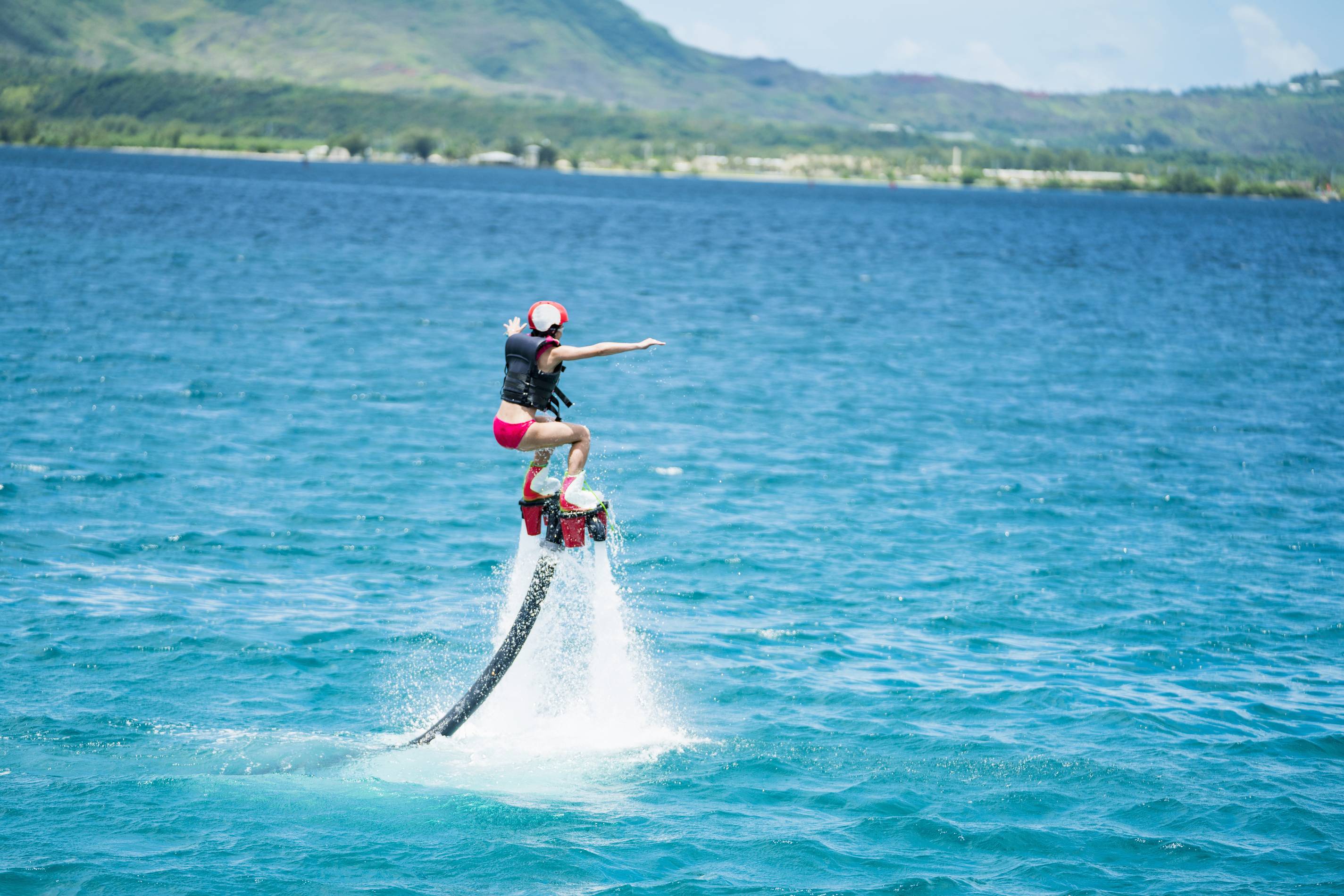 a woman rides a flyboard