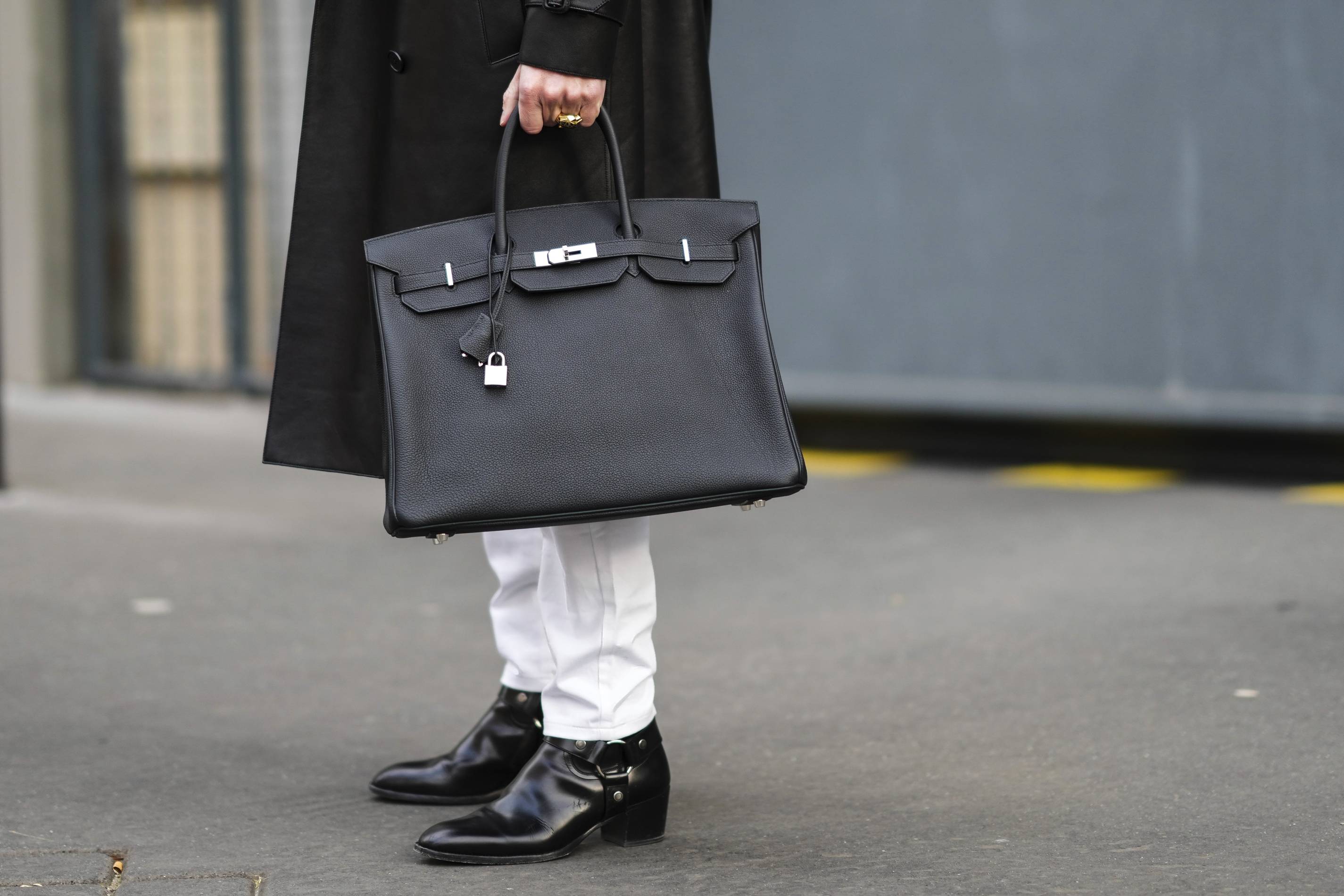Man holds Birkin bag at Paris Fashion Week