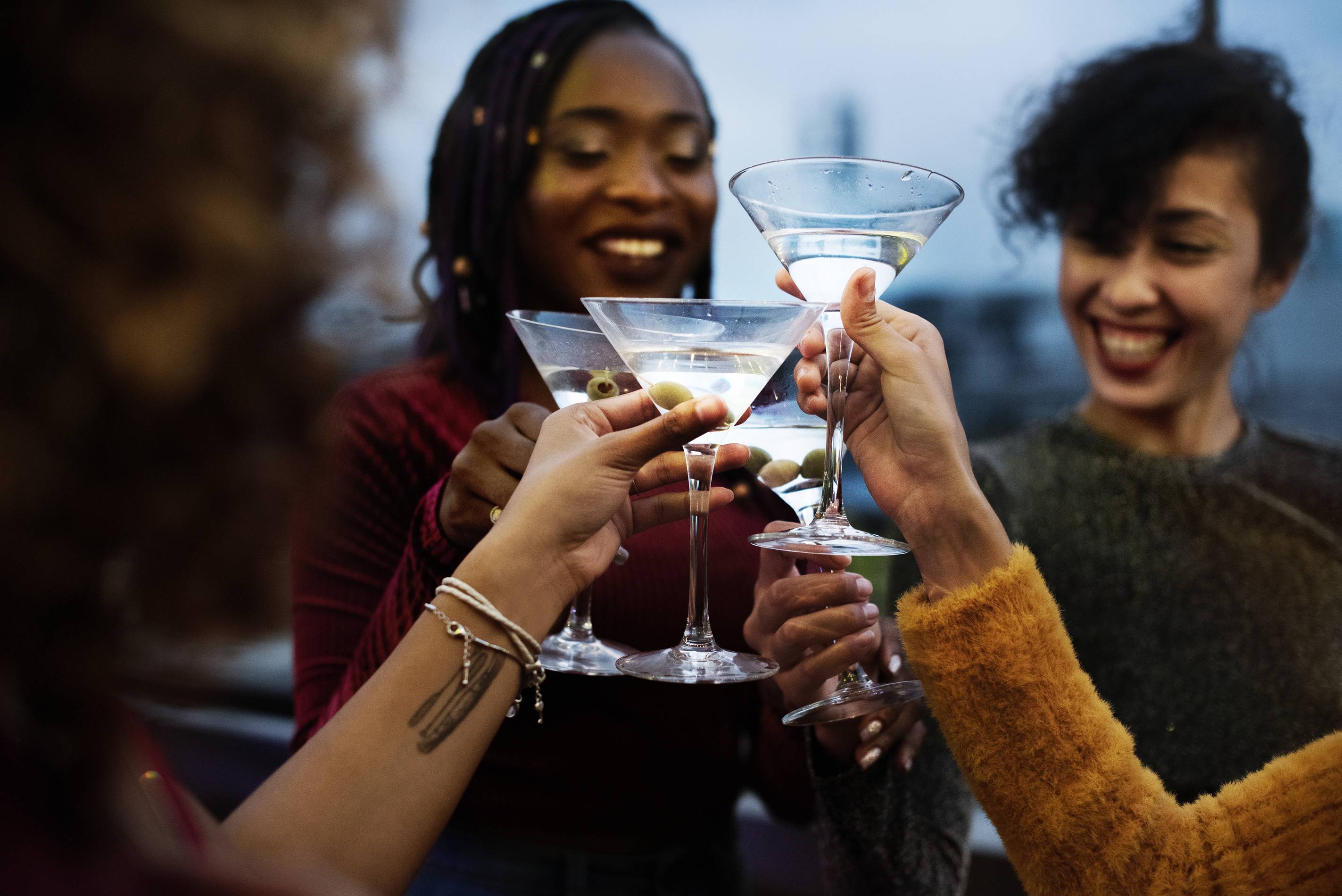 women toast with martinis