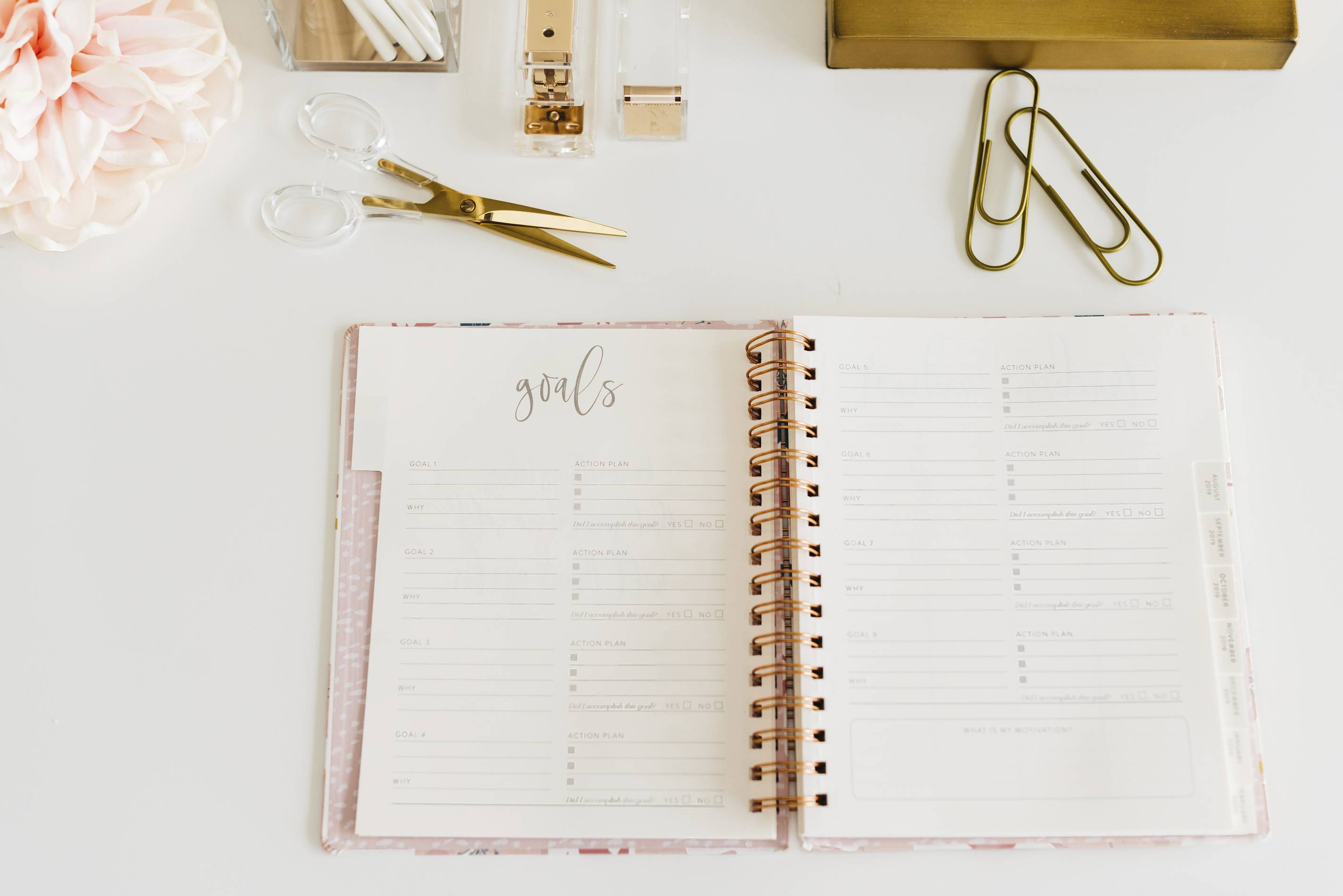 a beautiful planner with stationary accessories laid out on a table