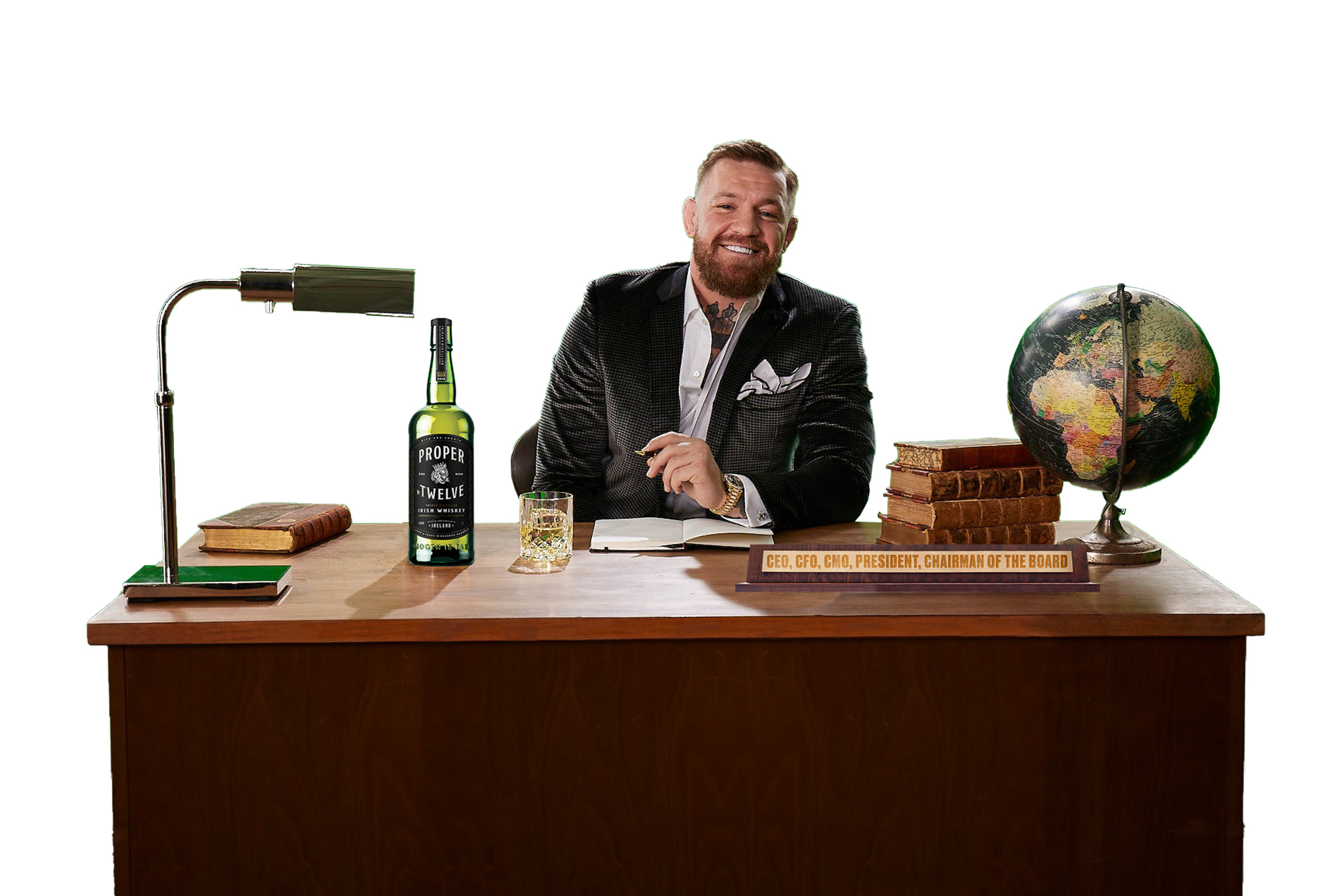 conor mcgregor at a desk with his proper no 12 whiskey bottle